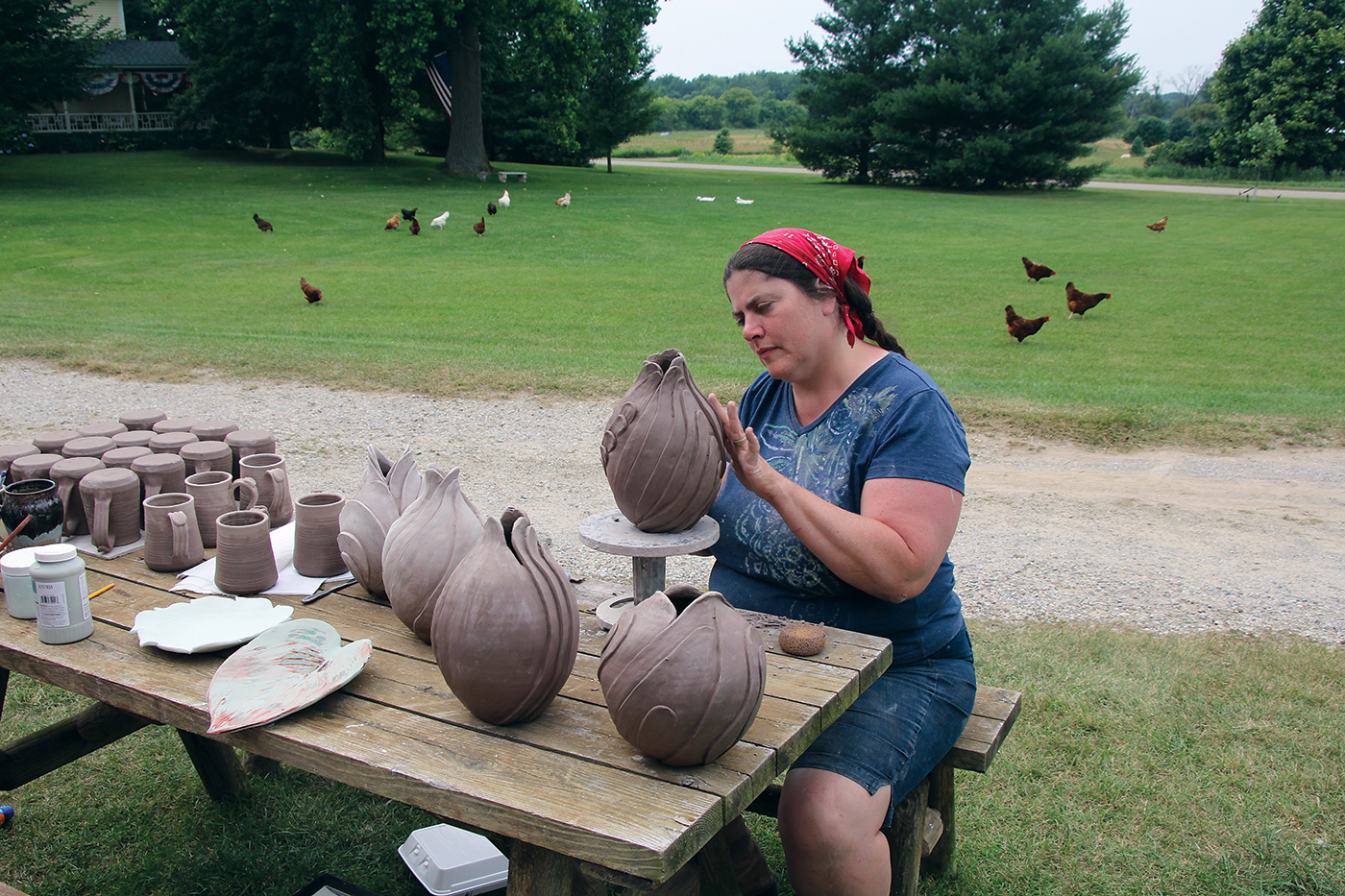 Dawn working on her tendril series outside her studio, her chickens in the yard behind her, July 2015. Photo by Robert Soltysiak.