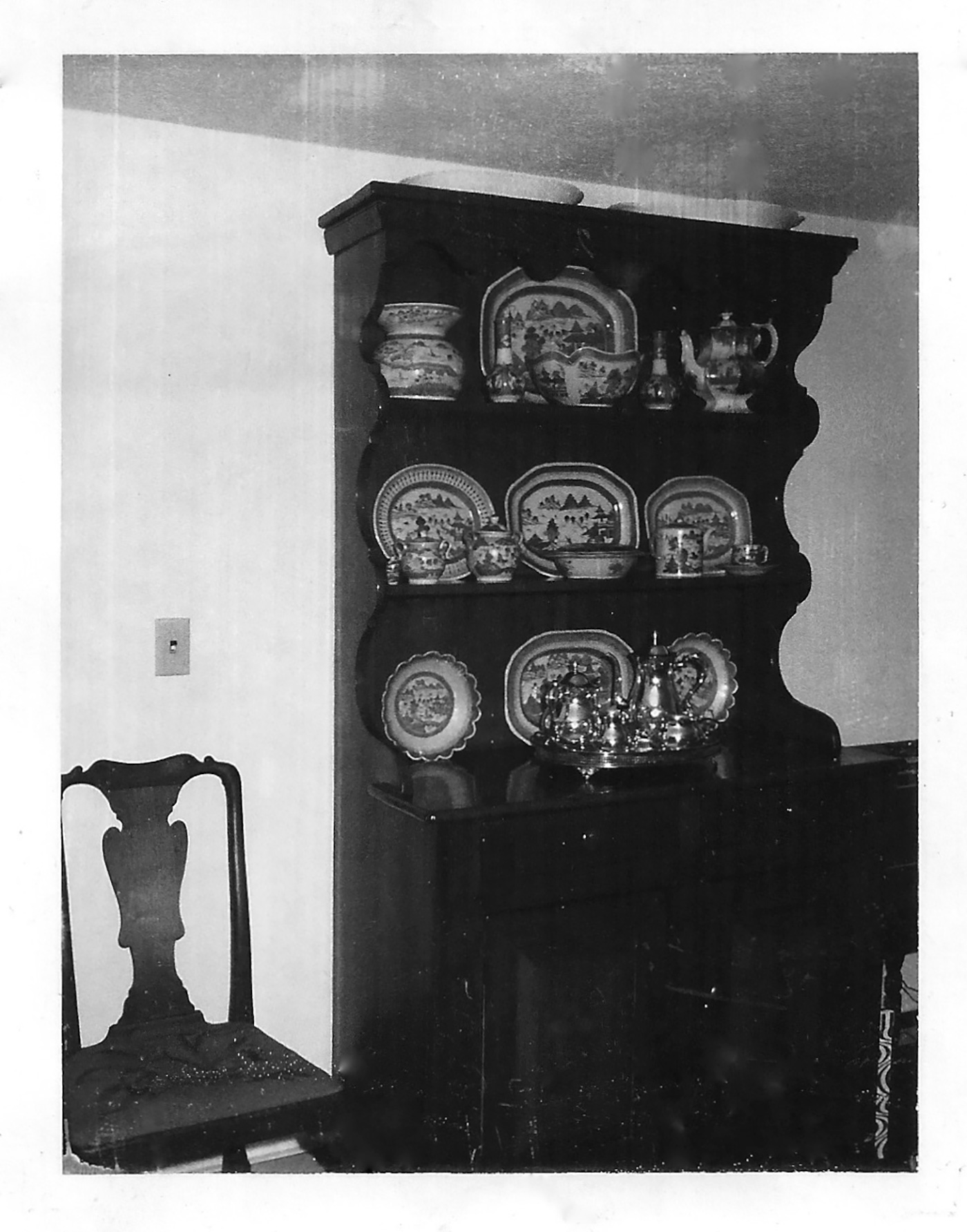 A cupboard in Basemans childhood home containing mostly blue and white Chinese export porcelain, 1970s.