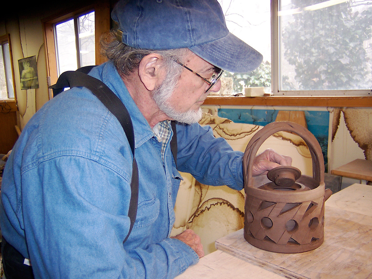 Norm Schulman working on a double wall teapot in studio, 2003