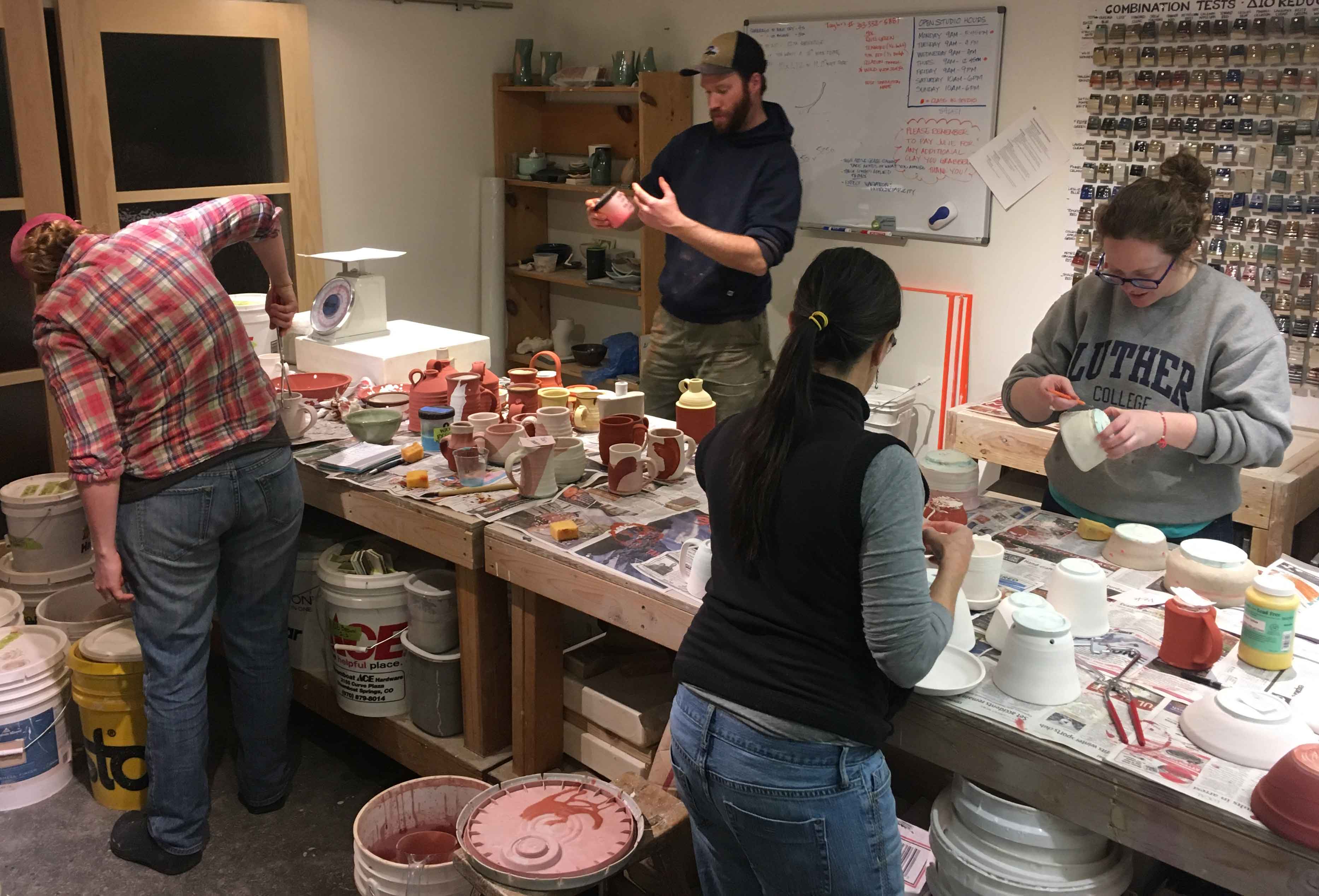 Students glaze their work in the ceramics classroom at Warehome Studios, 2017. 
