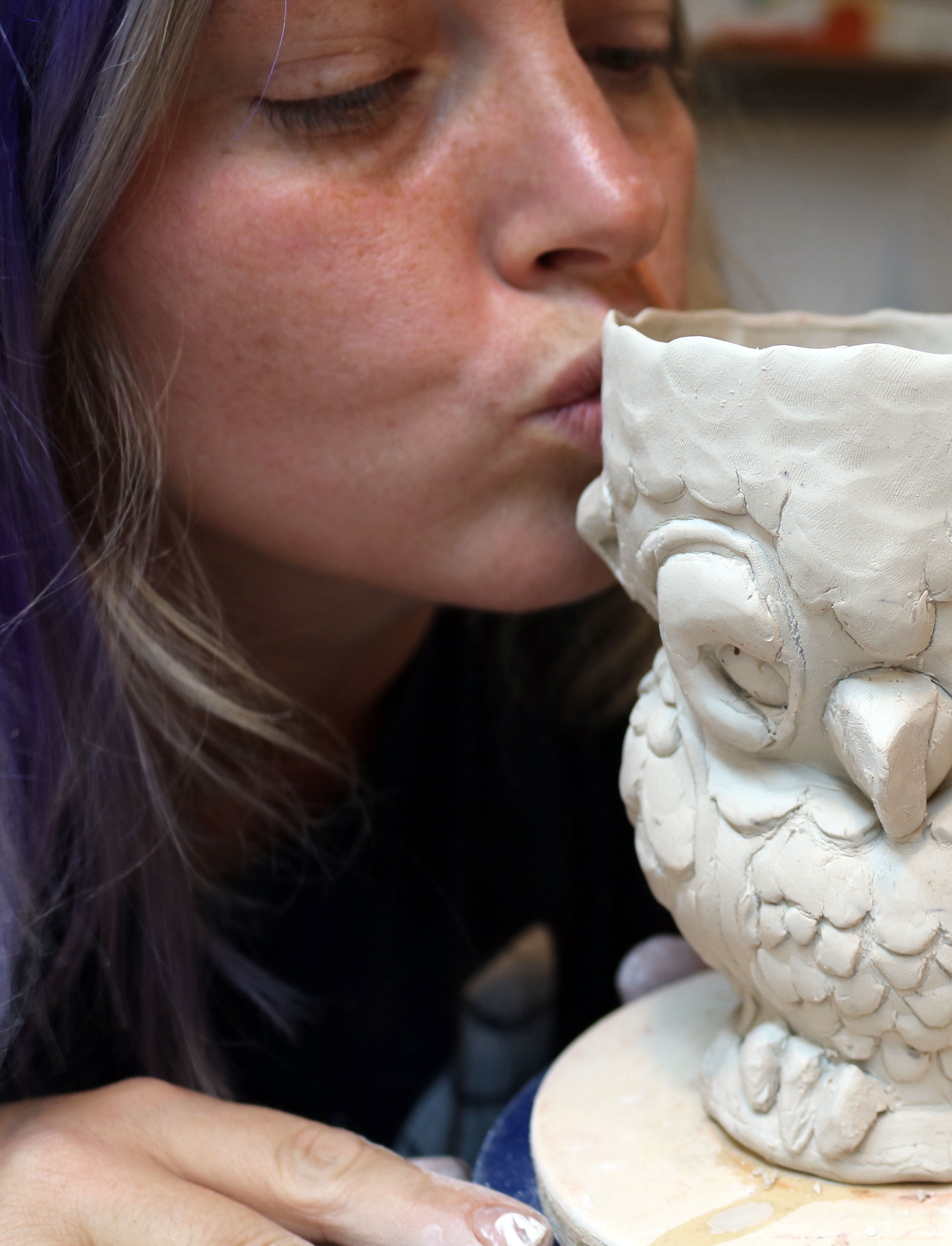 Cambric kissing her newly created owl cup in the studio, 2016.