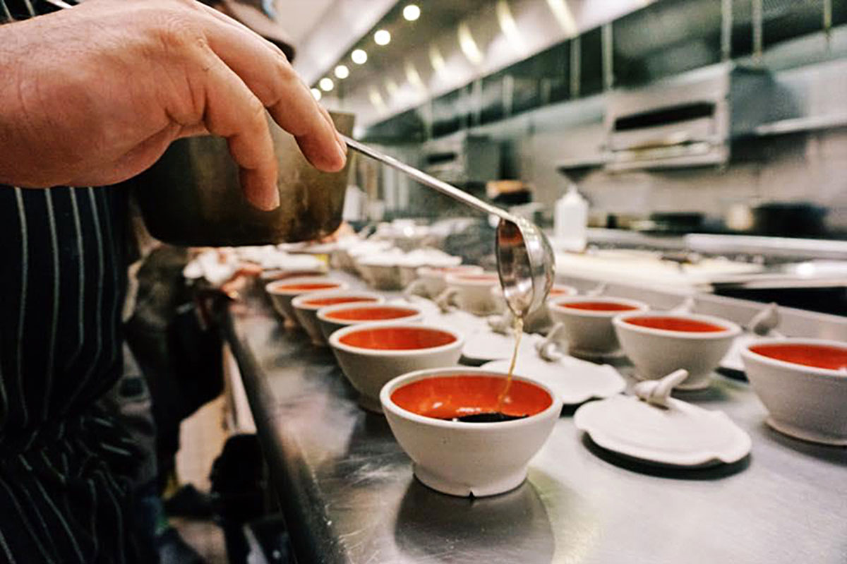 Leak ash dumplings being prepared for service. Steamer pots by Tim Compton, 5 in. diameter each, wheel-thrown  Cone 10 stoneware. Photograph by Audra Sternberg, 2017. 