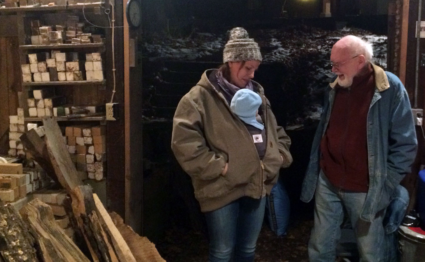 Kate and her son visit with Warren MacKenzie during a wood-firing.