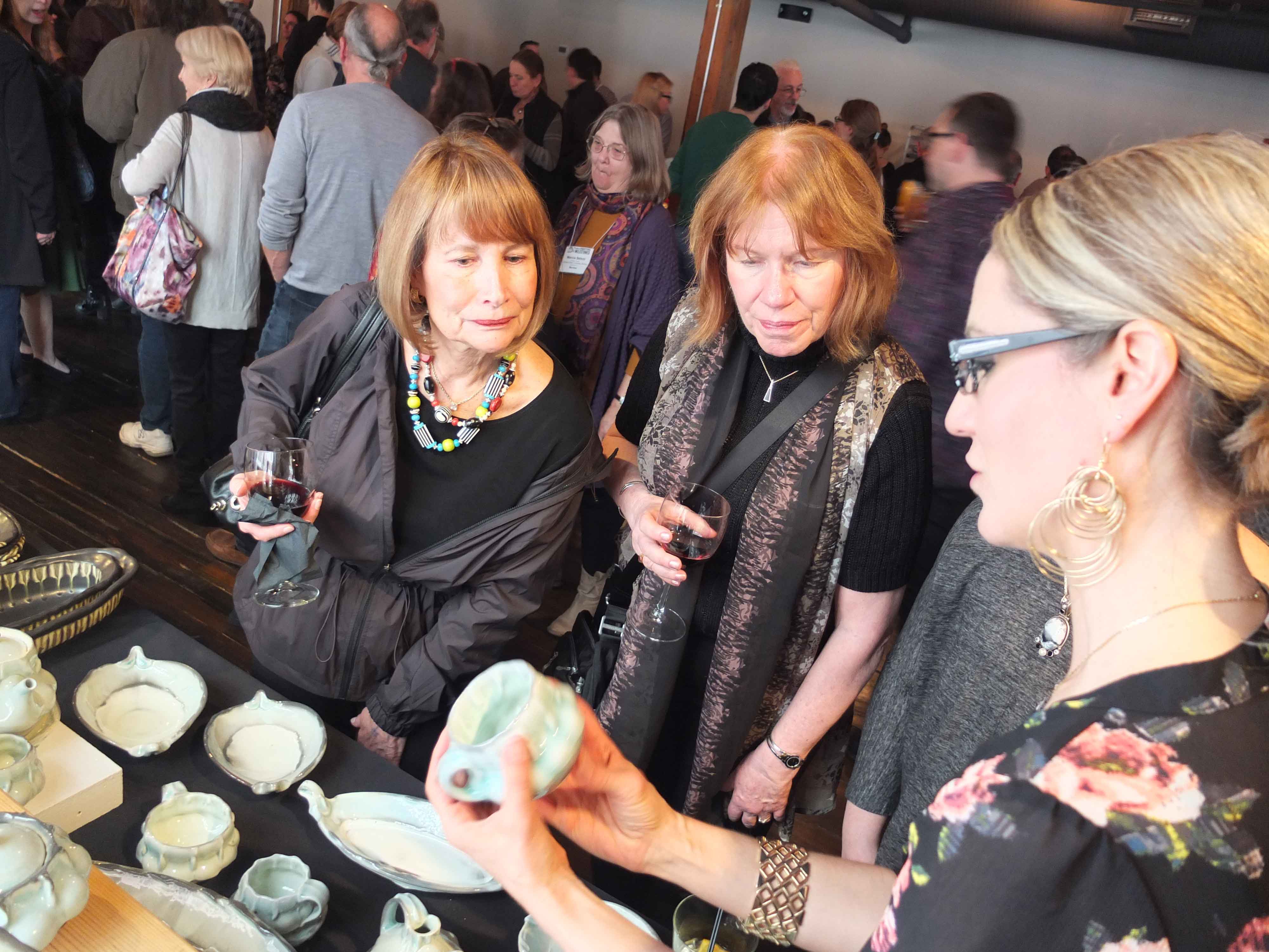 Brenda Lichman talks with guests about her work, photo by Hollis Engley.