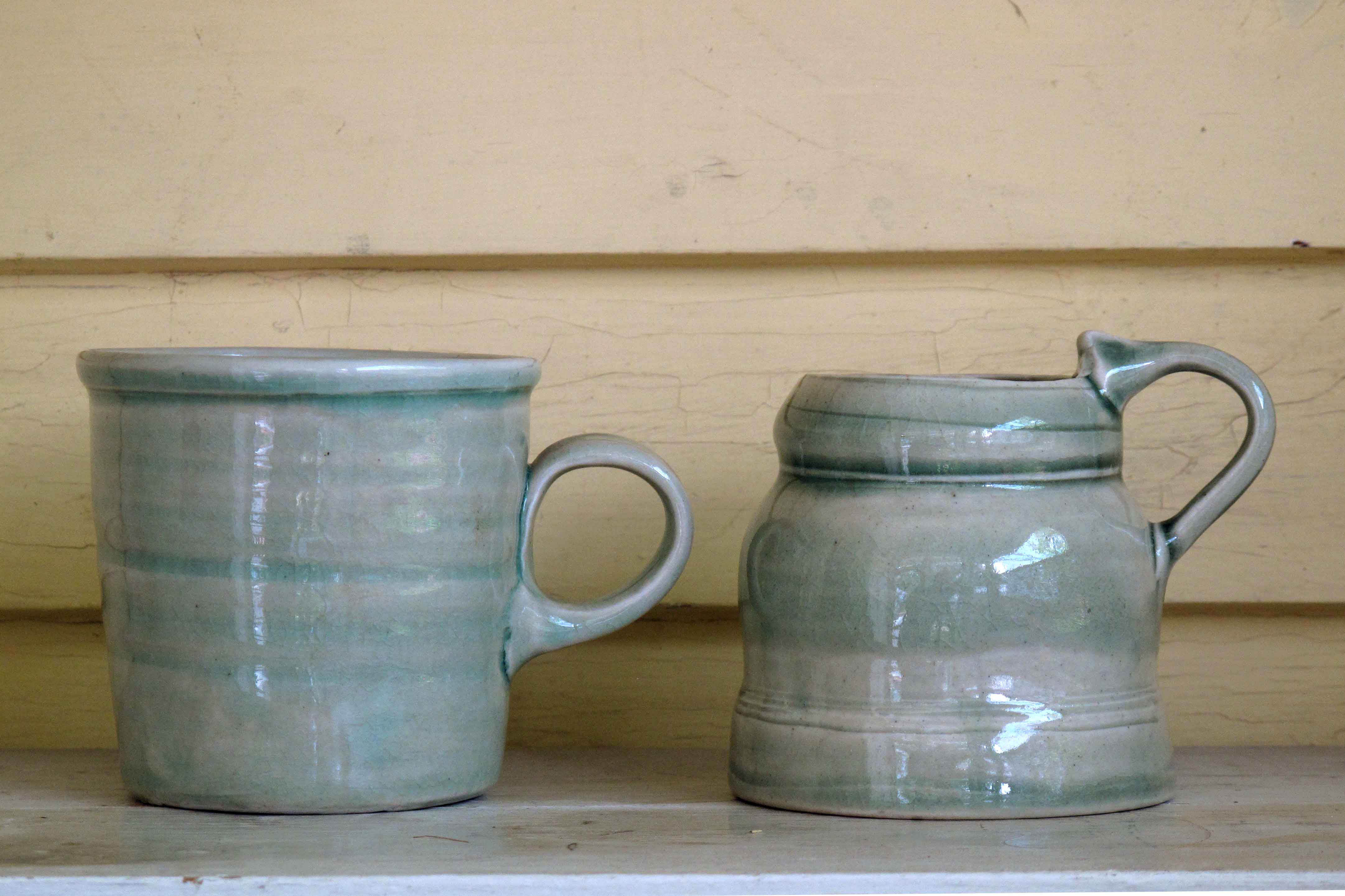 Mugs on a shelf in the author's home. 