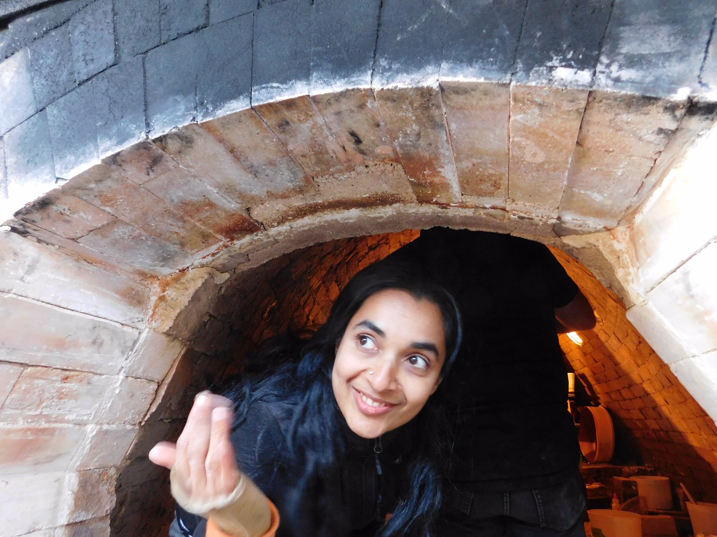 Ashwini Bhat at Chris Gustin's kiln. Photo by Hollis Engley, 2016.