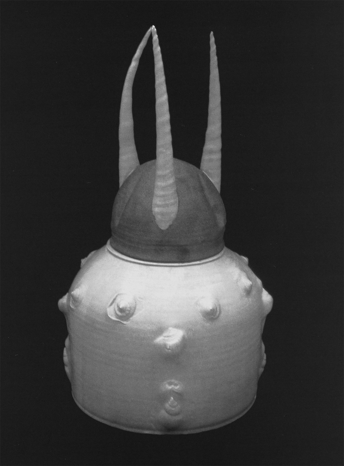 Norm Schulman. Viking, 1975. Porcelain, impressed shell molds, feldspathic glaze, copper-clad lid, 18 x 14 in.