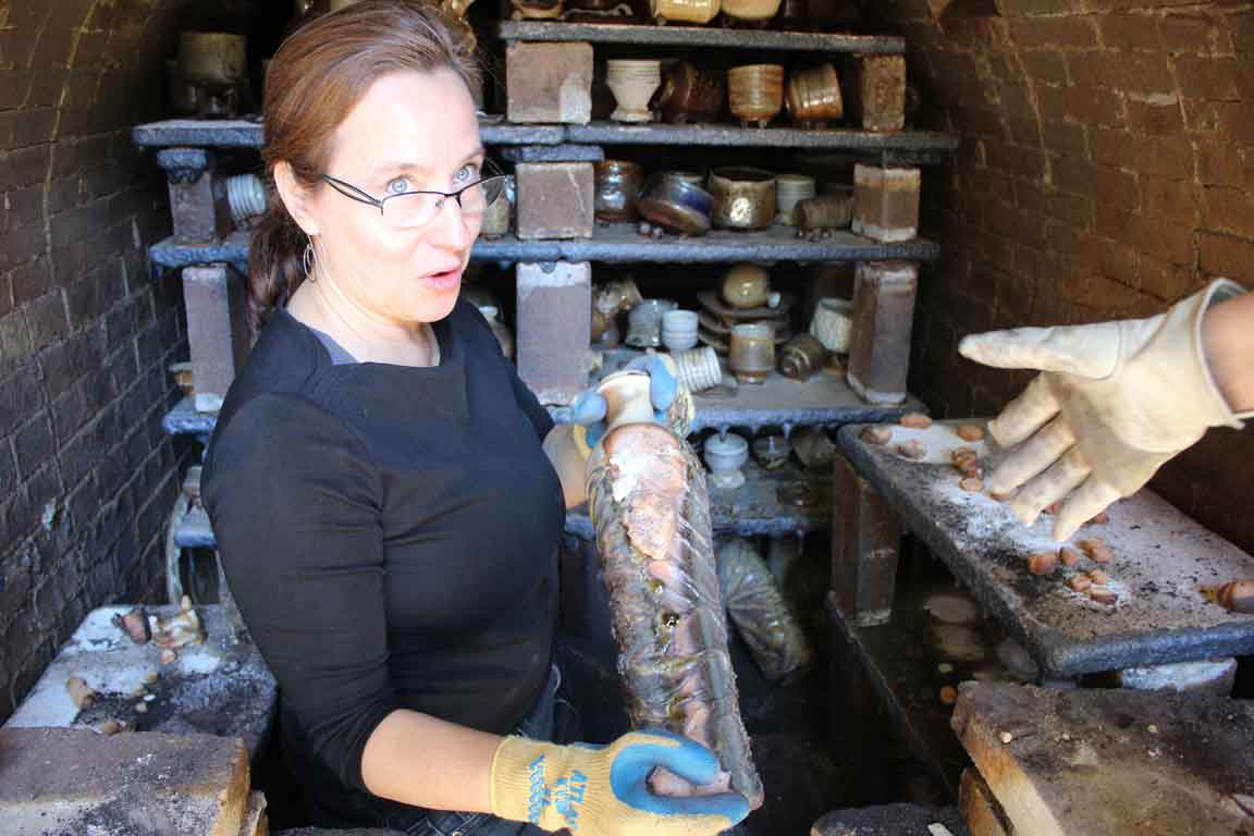 Muller unloads pots from the kiln, after it has been fired, and left to cool.