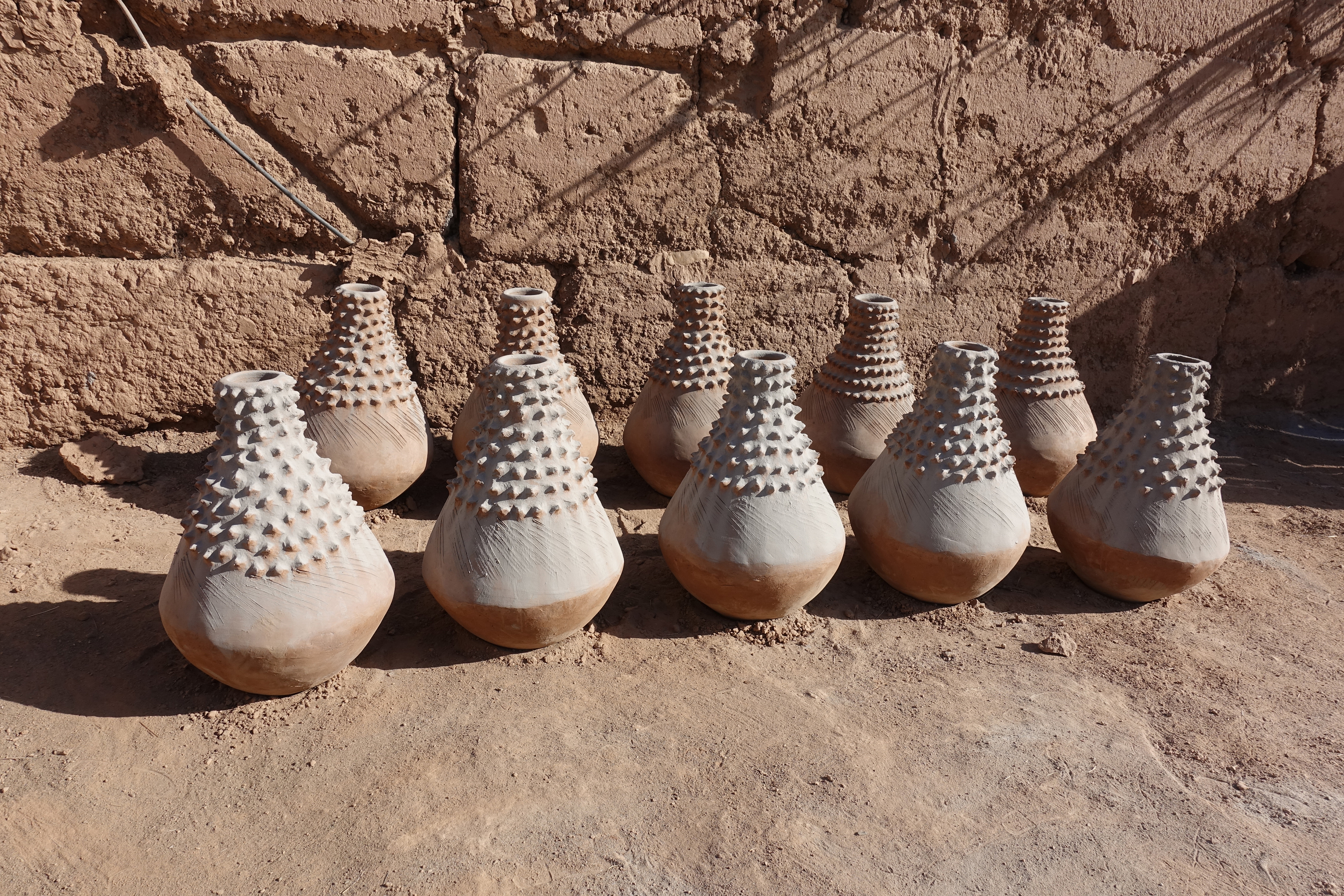 Astour, near Zagora, Oasis region. These unique pieces, nearly 30” high, were commissioned by someone in a big city as decorative pieces in a hotel or mall. The white coating is ash from the fire pit.