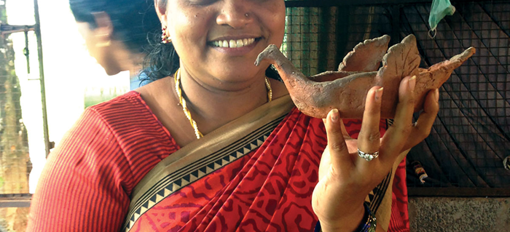 Meaghan’s student shows her Bird Puja Lamp post-firing. Mananthavady, Kerala, India, 2015. Photo by author.