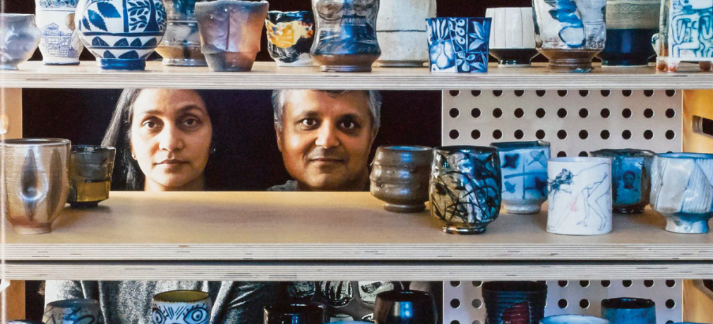 Jigna (left) and Sanjay (right) Jani behind various yunomi in their gallery, Iowa City, Iowa, USA, 2014. 
