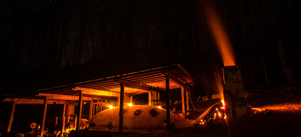 Noah Hughey-Commers’s anagama firing at night, Muddy Creek Pottery, Lovingston, Virginia. Photograph by Peter Rausse, 2015.
