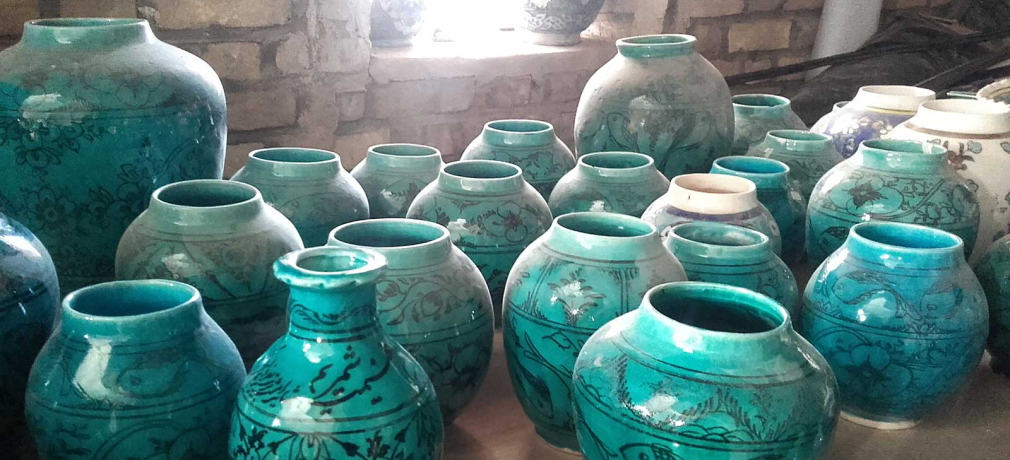 These turquoise pots represent a changing pottery tradition. The fish motif  is traditional to the area around the village of Shah Reza, but the forms  and color cater to current fashions.