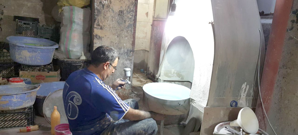 A spray booth at Sofale Mehran studio. This  pottery in Lalejin borrows ideas from  neighboring factories. 