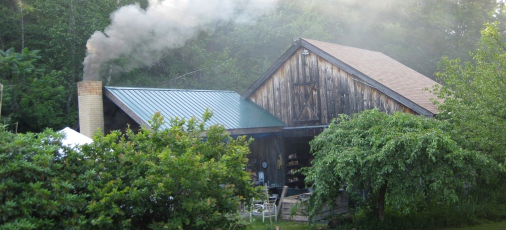 Entrance to Magnusson's studio barn and kiln shed, with a firing underway. Photo by the author, 2010.