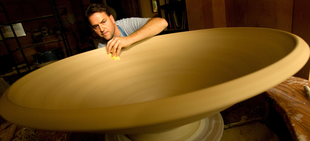 Ben making a large bowl for an installation, 2008. 16x48x48 in. Photograph by Jerry Wolford