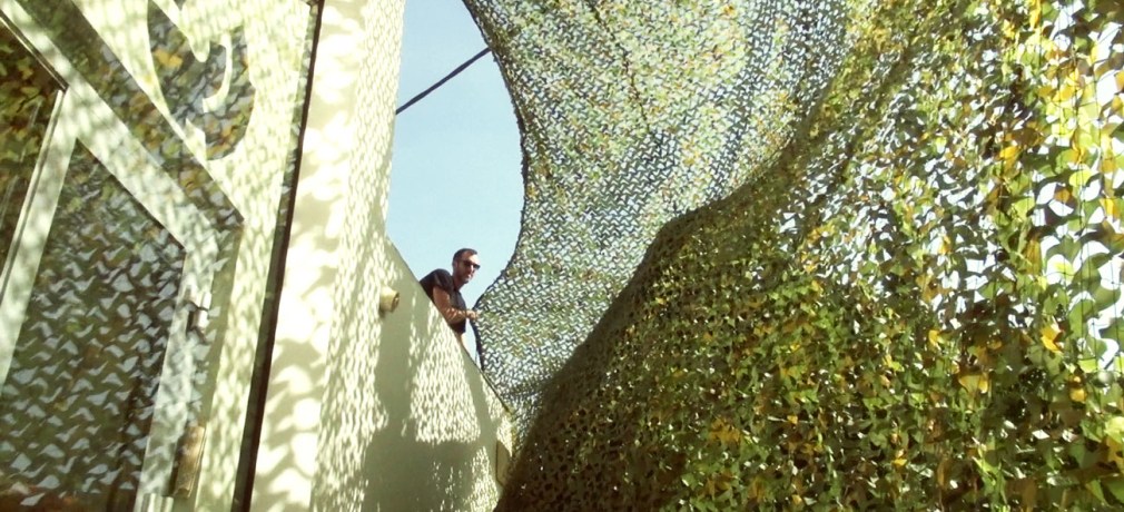 Ayelet Zohar, 'Villa in the Jungle,' 2016. Camouflage nets over Benyamini Center, supported by the Arts Department, Tel Aviv-Jaffa Municipality and the Yehoshua Rabinovich Tel Aviv Foundation for the Arts. Photograph by Yael Gur and Zamir Nega.
