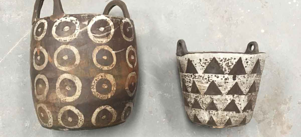Melissa Weiss. Basket (left, with circles), 2018. 20x12 in. Coil-built. Bucket (right, with triangles), 2017. 12 x 10 in. Slab- and mold-built. Both wild clay custom stoneware body, slip, ash glaze, iron wash; Cone 10 reduction, reduction cooled. 