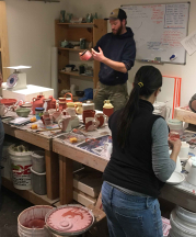 Students glaze their work in the ceramics classroom at Warehome Studios, 2017. 