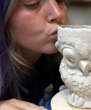 Cambric kissing her newly created owl cup in the studio, 2016.
