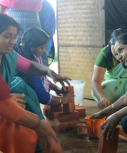 Mananthavady women cleaning and setting up stacks of bricks in preparation for the next layer of the kiln.