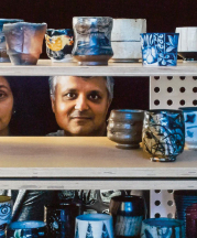 Jigna (left) and Sanjay (right) Jani behind various yunomi in their gallery, Iowa City, Iowa, USA, 2014. 