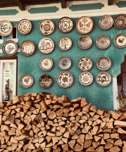 Woodpile and plates outside a potter’s home in Olari, Romania. Plates displayed on the outside of a home signify a pottery. All photos by Paula Marian, 2017.
