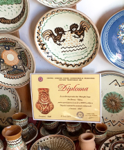 Gheorghe Iorga’s pottery display and certificate from his participation in a national clay show.