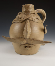 A collaborative piece by McCarthy and a student, Ben Z., made as a modern reinterpretation of face jugs. Wheel-thrown stoneware, altered, wood-fired to Cone 10, salt-glazed, 13.5 x 10 x 9 in.