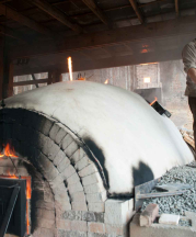 Noah Hughey-Commers firing his kiln at Muddy Creek Pottery, Lovingston, Virginia. Photograph by Stephanie Gross.