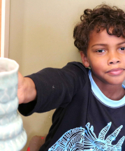 Cambric's oldest son, Zen, with ceramic cup. Photo by Mom, 2016.