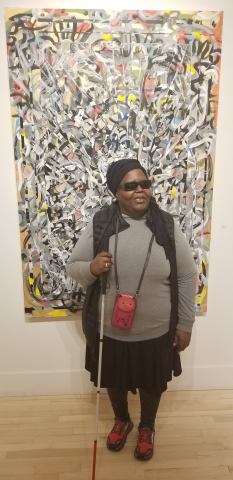 Donna Ray at one of the many art receptions she frequented in Minneapolis in front of the Ta-cumba Aiken painting About It, exhibited at Artistry.