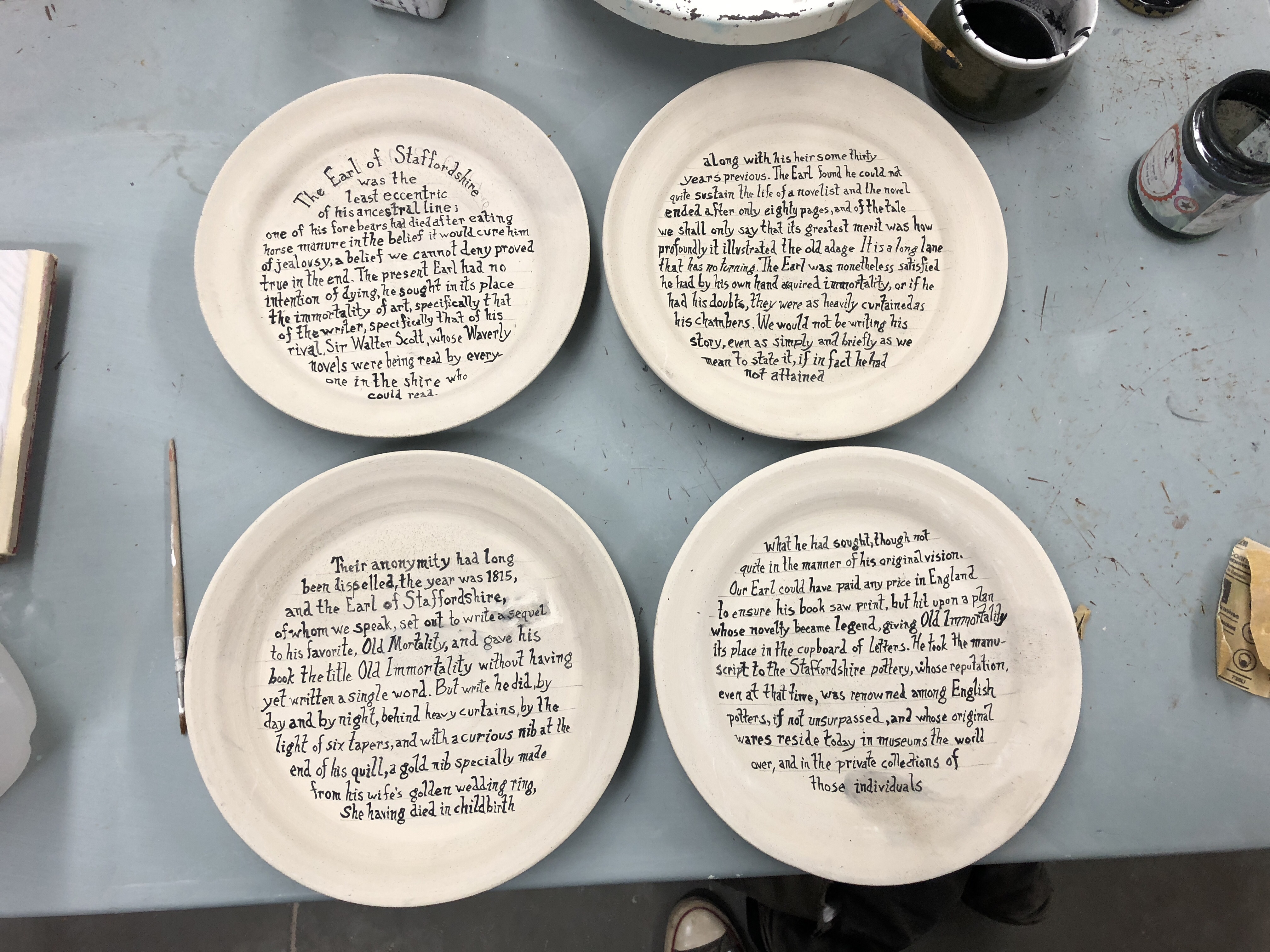 A dinner set for poet Mary Ruefle’s April 2020 reading at UMass Amherst has as a centerpiece a plate set inspired by her short prose piece Old Immortality. 