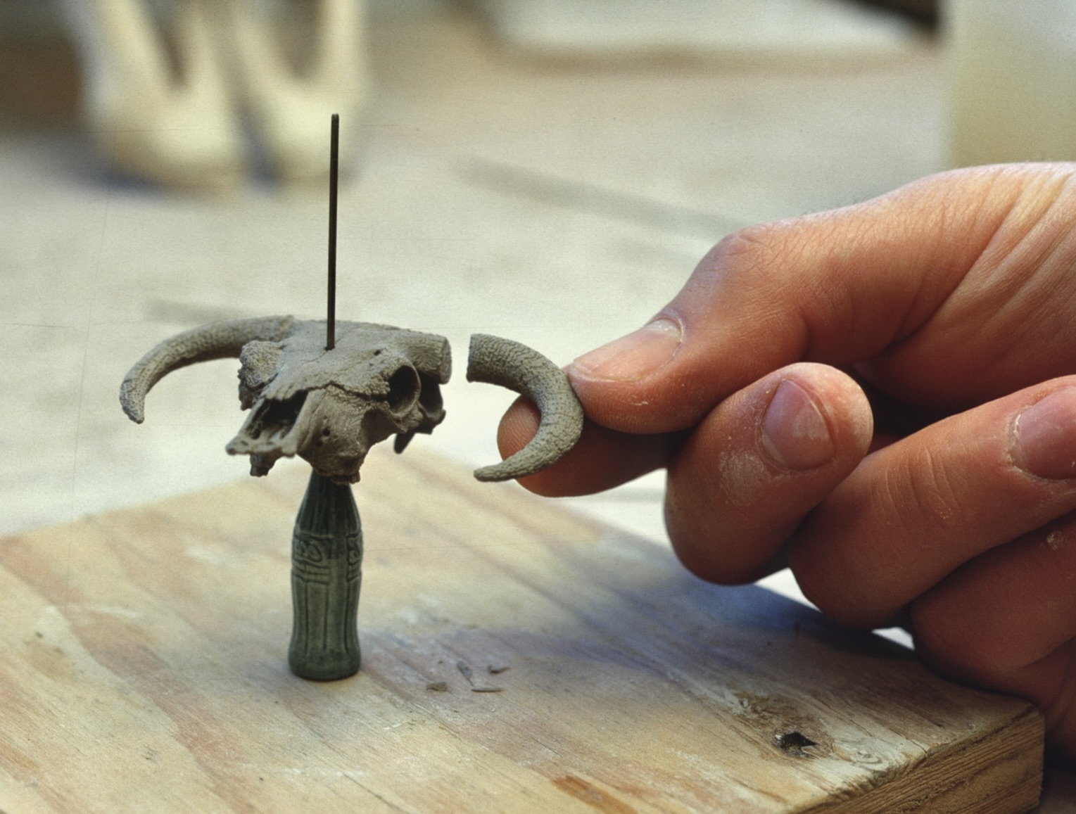 Attaching horn to carved porcelain skull.  Notkin studio, Myrtle Point, OR, 1978. Photo courtesy of Richad Notkin.