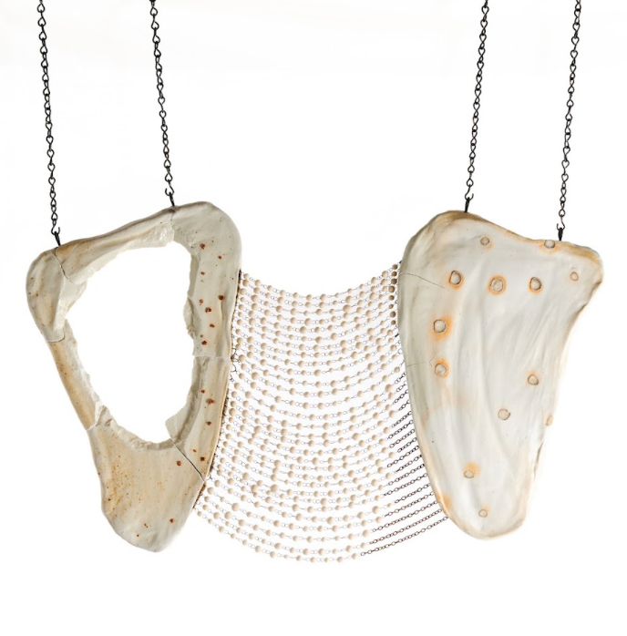 On Their Shoulders, 365 porcelain beads hung between two sculpted porcelain shoulder blades, and Enduring Light, 7 floating porcelain luminaries in a blown glass bowl with shards of broken porcelain on a pedestal. Photo courtesy of Joseph Robinson.